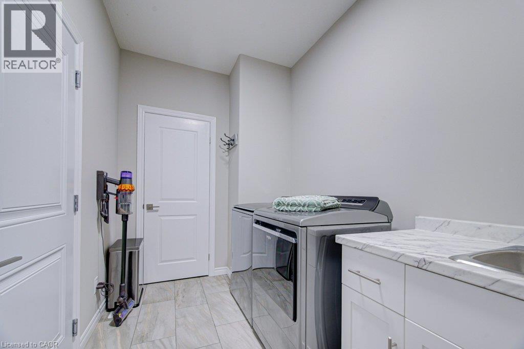 Dedicated laundry area featuring tile flooring and light gray walls - 15 Matheson Crescent, Innerkip, ON - Indoor Photo Showing Laundry Room