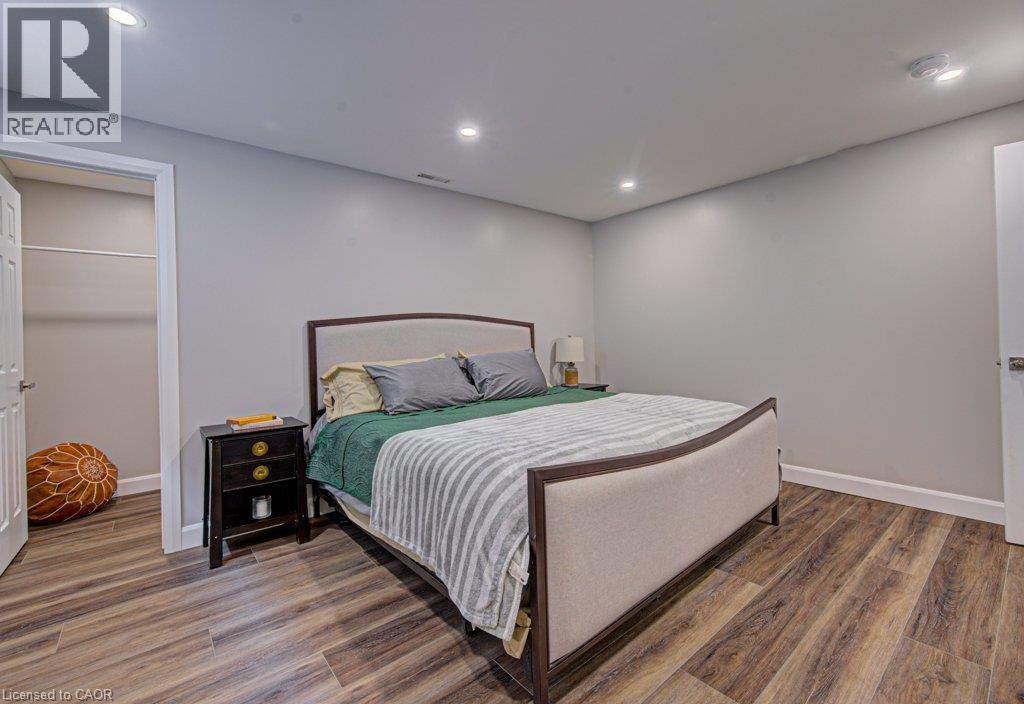 Spacious room featuring wood-finish flooring, recessed lighting, and light gray walls - 15 Matheson Crescent, Innerkip, ON - Indoor Photo Showing Bedroom