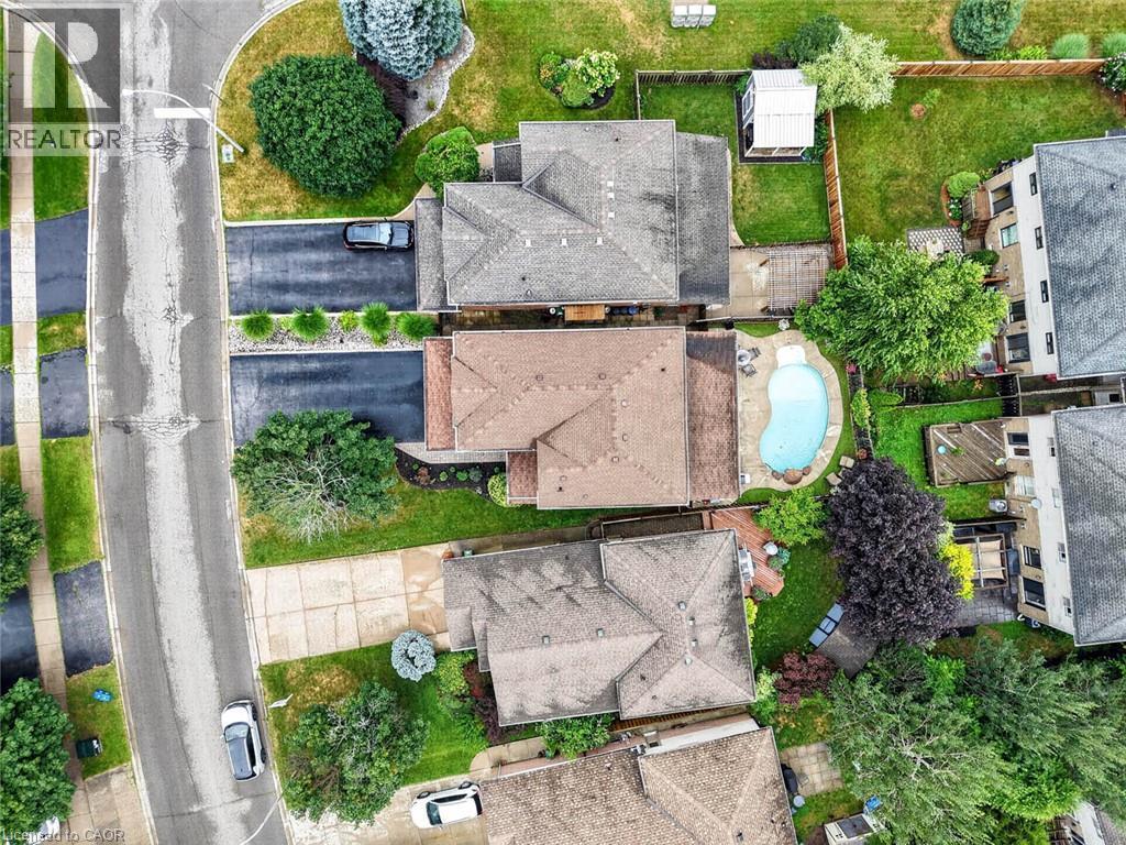 Aerial perspective showcasing multiple properties, including one with an in-ground swimming pool - 43 Liam Drive, Ancaster, ON - Outdoor