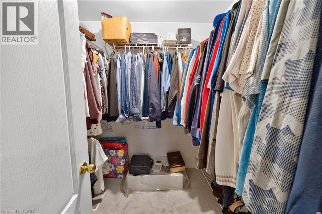 Walk-in closet featuring white wire shelving, hanging rods, and carpet flooring - 43 Liam Drive, Ancaster, ON - Indoor With Storage