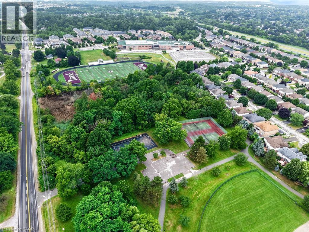 Aerial perspective showcasing a residential area with mature trees and green spaces - 43 Liam Drive, Ancaster, ON - Outdoor With View