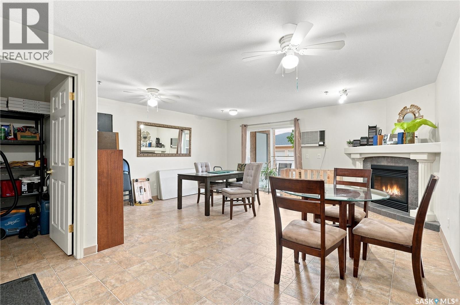 209 215 Lowe Road, Saskatoon, SK - Indoor Photo Showing Dining Room With Fireplace