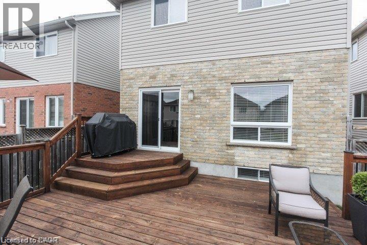 Expansive wood-finish deck with tiered steps, dark wood railings, and privacy fencing - Upper-313 Featherstone Crescent, Kitchener, ON - Outdoor With Deck Patio Veranda With Exterior