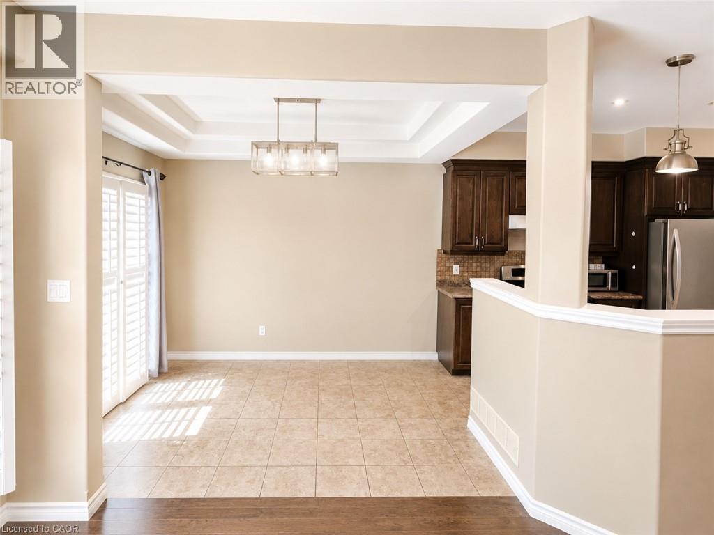 Open-concept space featuring a coffered ceiling, tile flooring, and a modern rectangular chandelier - Upper-313 Featherstone Crescent, Kitchener, ON - Indoor Photo Showing Kitchen