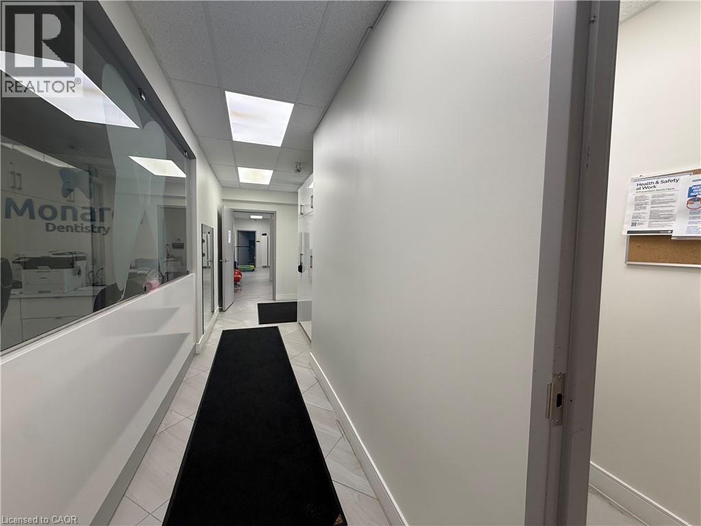 Hallway featuring tiled flooring, recessed ceiling lighting, and a frosted glass wall - 51 Benton Street, Kitchener, ON