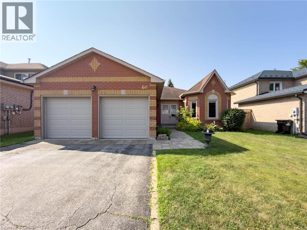 Brick exterior with dual garage doors and a stone paver walkway leading to the front entrance - 60 Attwood Drive, Cambridge, ON - Outdoor