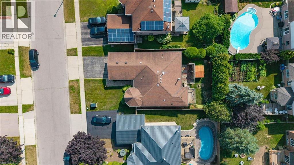 Expansive property featuring a brown shingle roof, established landscaping, and a paved driveway - 60 Attwood Drive, Cambridge, ON - Outdoor With View
