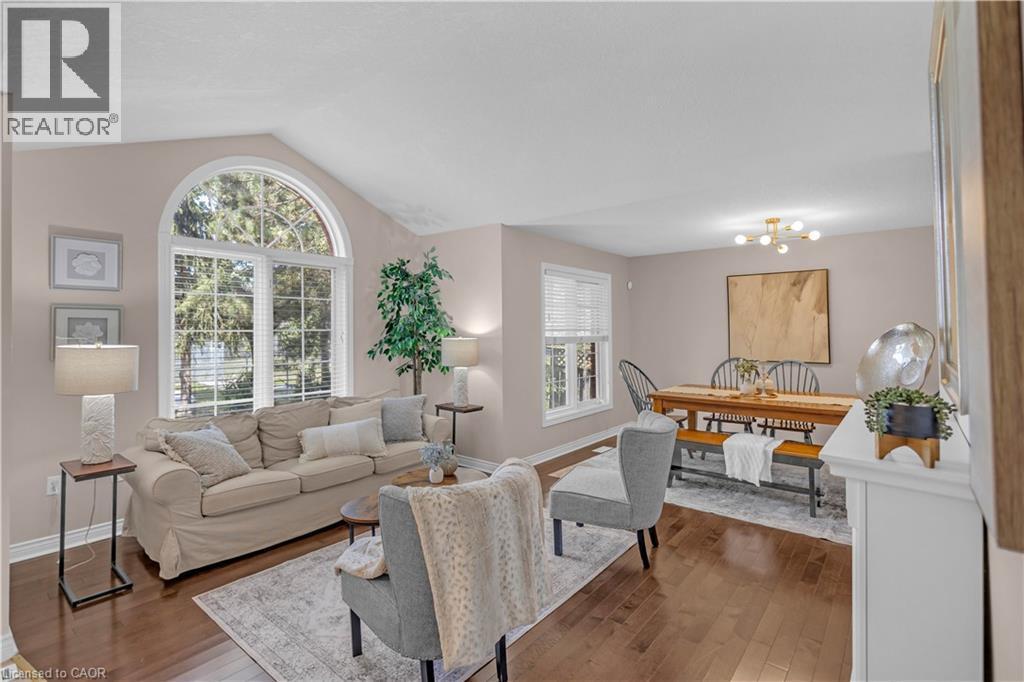 Living area featuring vaulted ceilings and a large arched window - 65 Thistlemoor Drive, Caledonia, ON - Indoor Photo Showing Living Room