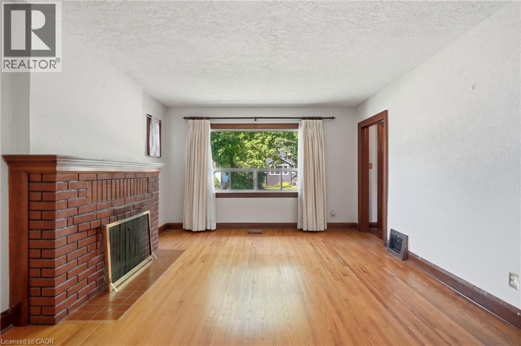 Living Room with fireplace & hardwood flooring - 188 Troy Street, Mississauga, ON - Indoor With Fireplace