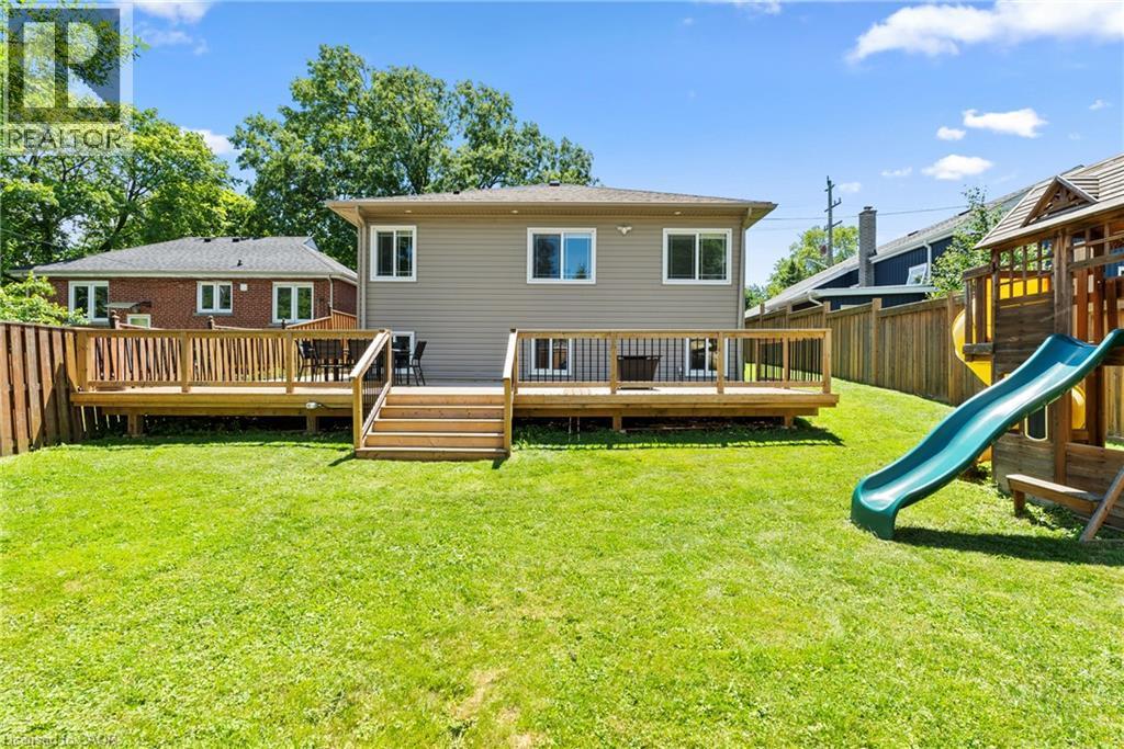 Expansive backyard with a large wood-finish deck, multiple access points, and a level grass lawn - 258 Sanatorium Road, Hamilton, ON - Outdoor With Deck Patio Veranda With Exterior