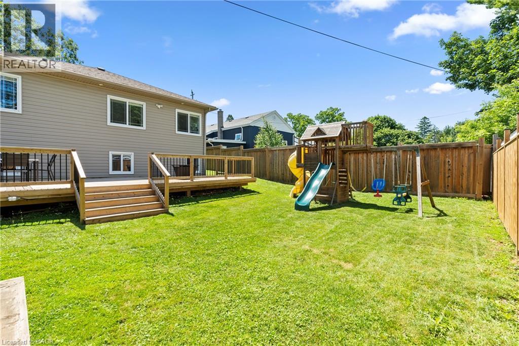 Expansive rear yard featuring a multi-level wood deck with stairs, a wooden privacy fence, and a green lawn - 258 Sanatorium Road, Hamilton, ON - Outdoor With Deck Patio Veranda