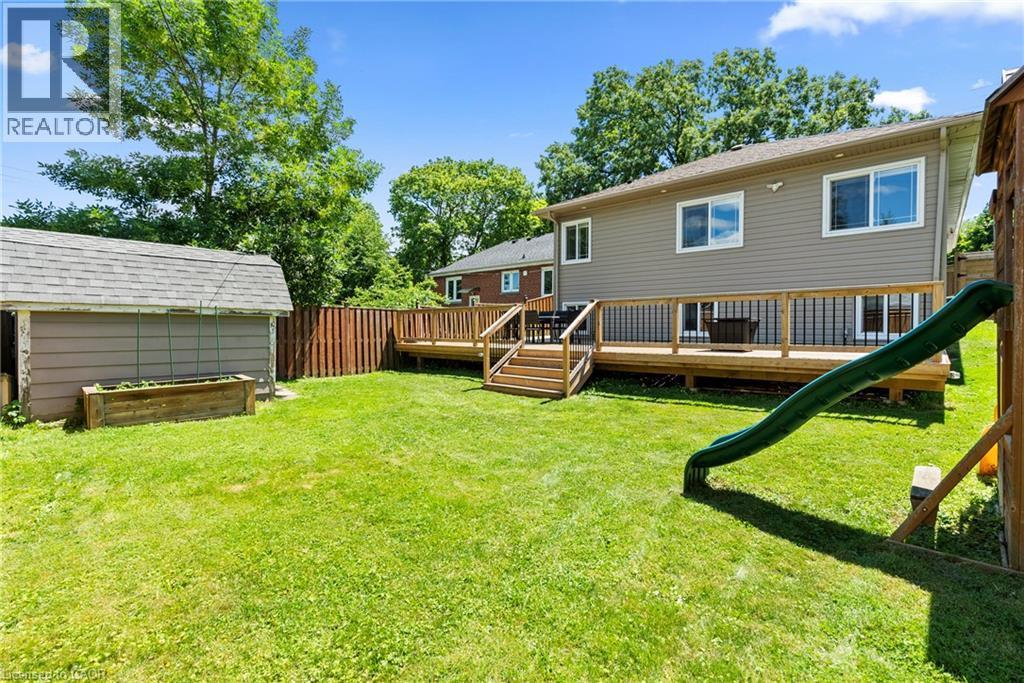 Expansive green lawn with a wood privacy fence - 258 Sanatorium Road, Hamilton, ON - Outdoor With Deck Patio Veranda With Exterior