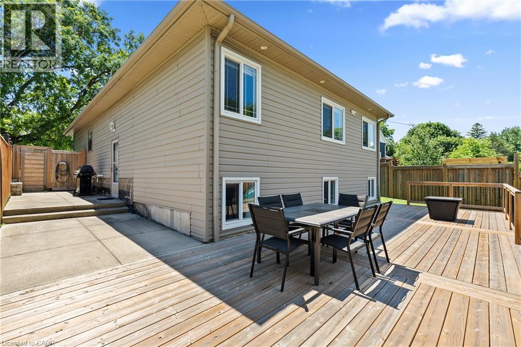 Expansive outdoor living area featuring a multi-level wood deck, a concrete patio, and neutral siding on the exterior - 258 Sanatorium Road, Hamilton, ON - Outdoor With Deck Patio Veranda With Exterior