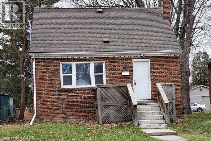 Brick facade home featuring a gabled roof and a prominent front door - 84 Ewen Road, Hamilton, ON - Outdoor