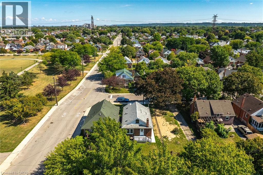 Aerial perspective showcasing a residential neighborhood with a prominent street and green spaces - 128 Auburn Avenue, Hamilton, ON