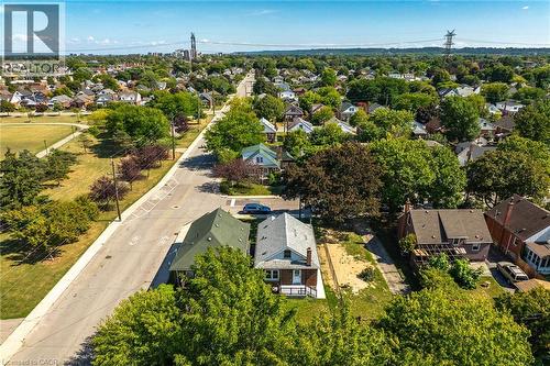 Aerial perspective showcasing a residential neighborhood with a prominent street and green spaces - 128 Auburn Avenue, Hamilton, ON 