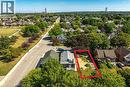 Vacant lot featuring existing paved driveway and mature surrounding trees - 128 Auburn Avenue, Hamilton, ON 