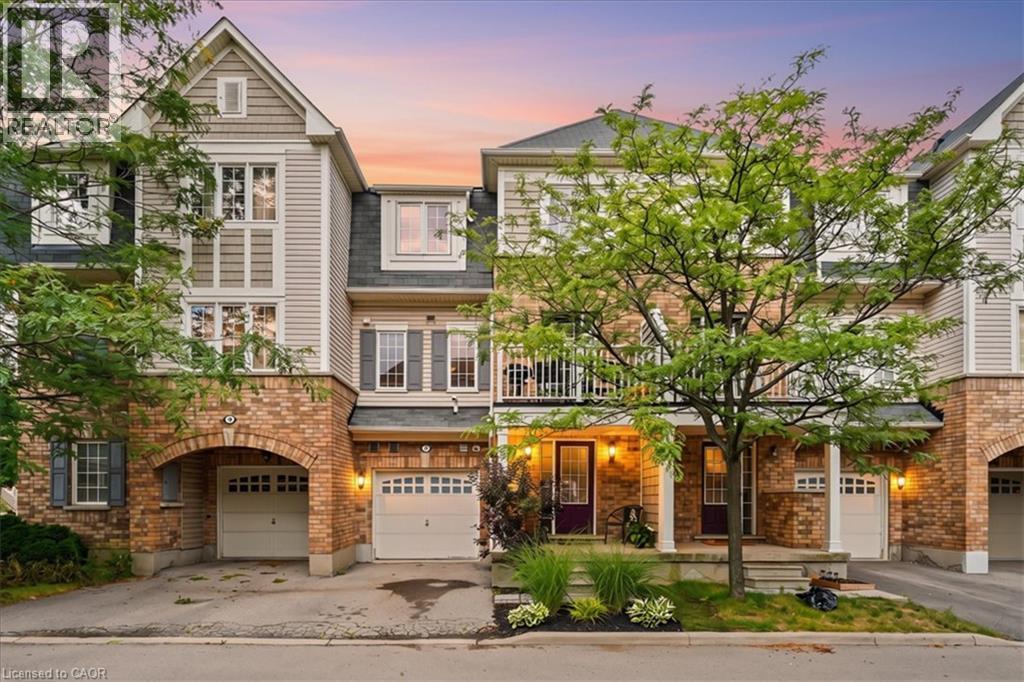 Multi-level townhome featuring a brick and siding facade, private garage, front porch, and second-story balcony - 7 Sirente Drive Unit# 7, Hamilton, ON - Outdoor With Balcony With Facade