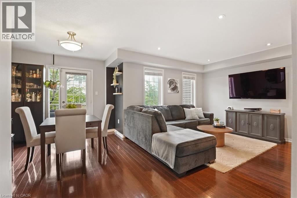Open concept living space featuring wood-finish flooring, recessed lighting, and a neutral color palette - 7 Sirente Drive Unit# 7, Hamilton, ON - Indoor