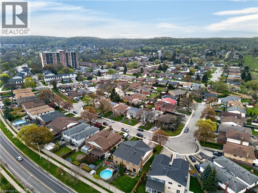 Expansive aerial perspective showcasing a residential neighborhood with varied single-family homes and mature trees - 56 Brookstream Court, Hamilton, ON - Outdoor With View