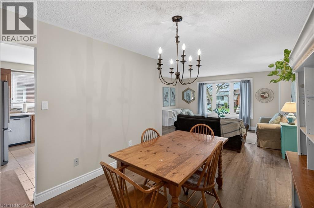 Open-concept living space with wood-finish flooring - 56 Brookstream Court, Hamilton, ON - Indoor Photo Showing Dining Room
