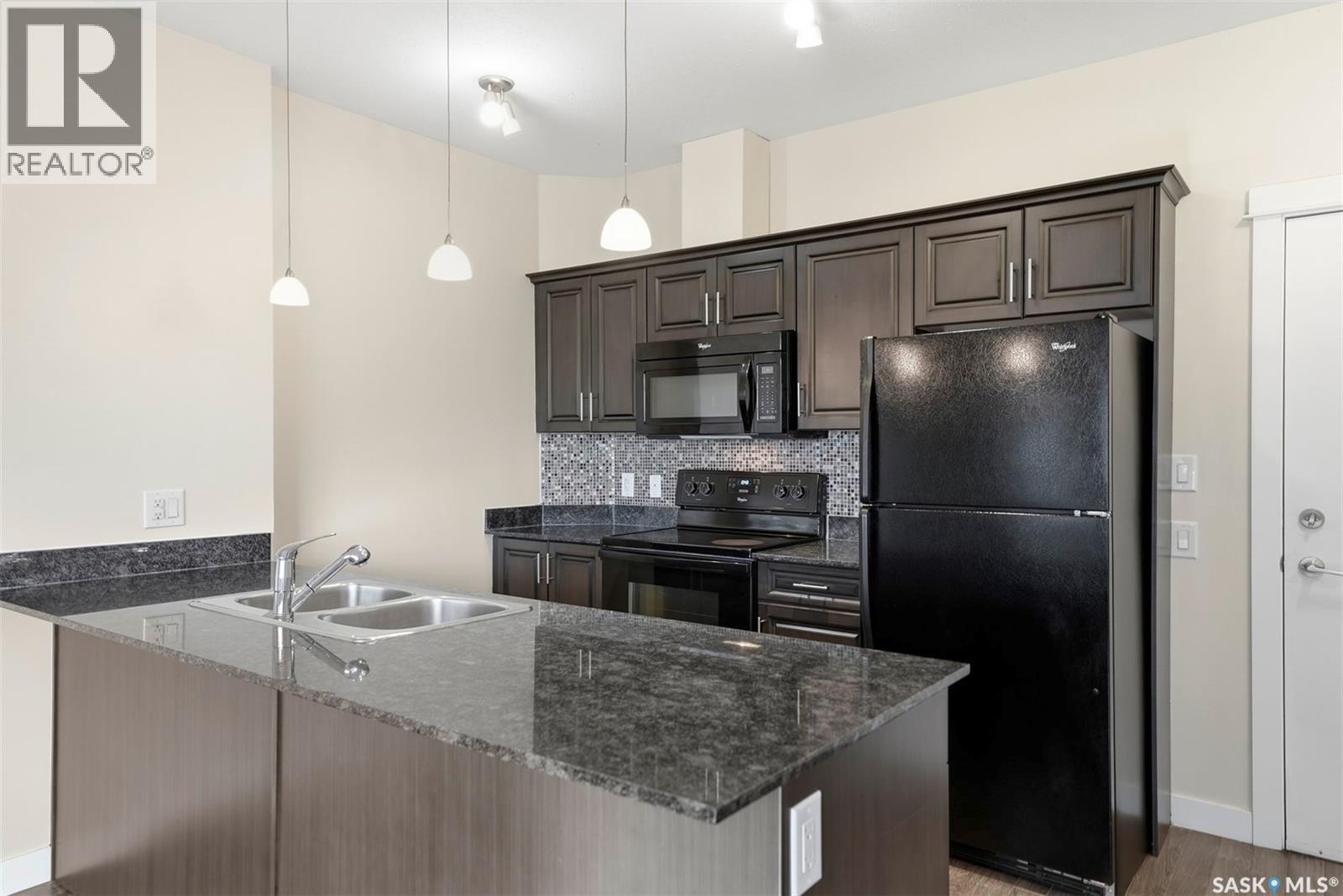 104 714 Hart Road, Saskatoon, SK - Indoor Photo Showing Kitchen With Double Sink