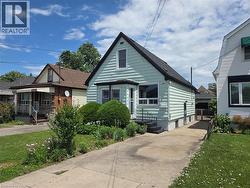 Mint green siding exterior with a black shingled roof - 