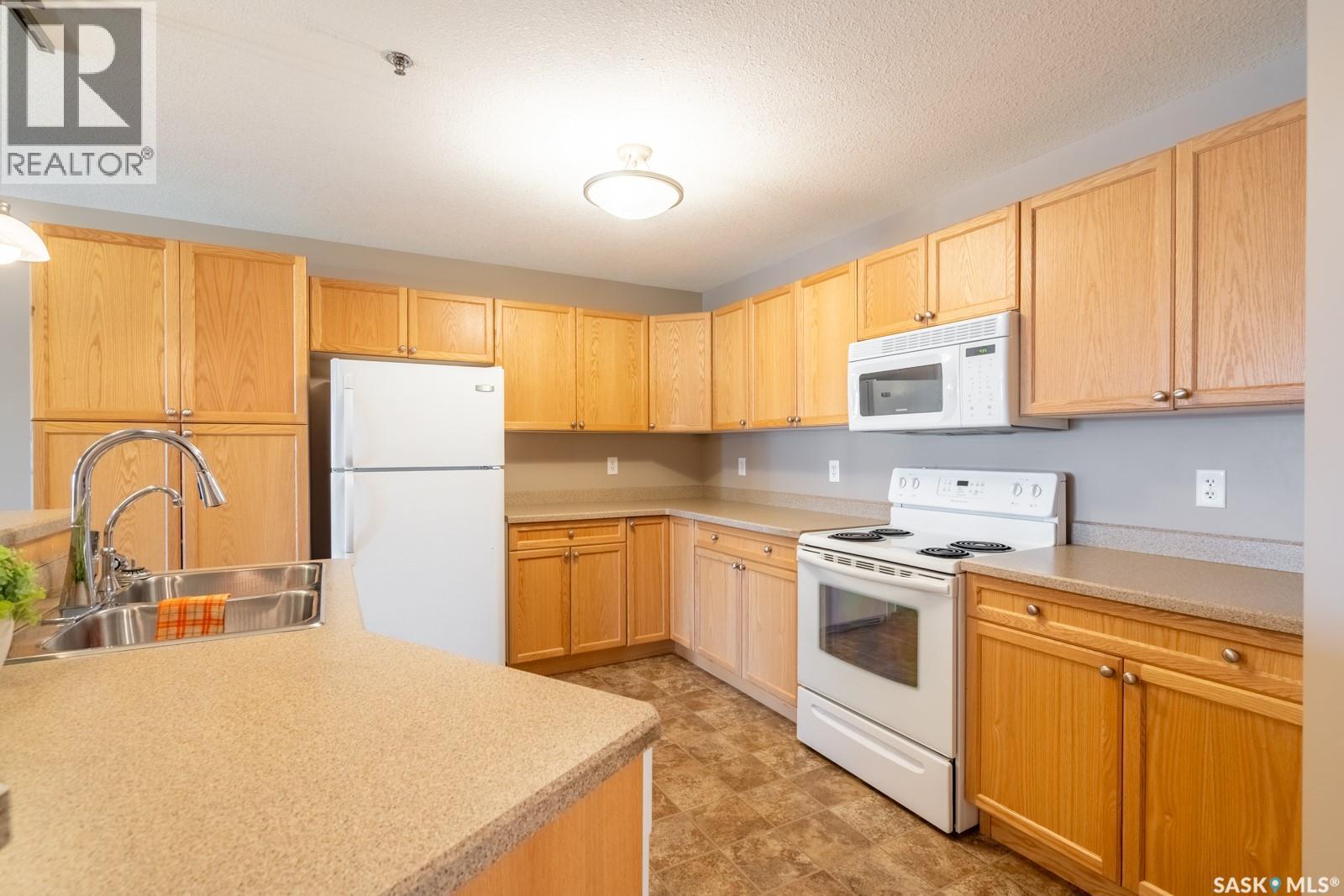 108 6345 Rochdale Boulevard, Regina, SK - Indoor Photo Showing Kitchen With Double Sink