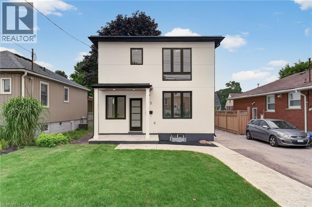 Modern two-story residence featuring a white facade and black-framed windows - 325 Queensdale Avenue E, Hamilton, ON