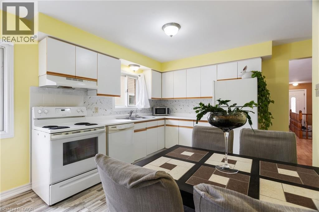 LARGE EAT IN KITCHEN WITH 3 FRIDGES - 25 Saunby Street, London, ON - Indoor Photo Showing Kitchen With Double Sink