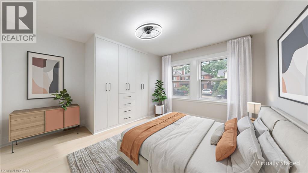 Integrated white cabinetry with matte black pulls and drawer storage - 59 Longwood Road N, Hamilton, ON - Indoor Photo Showing Bedroom