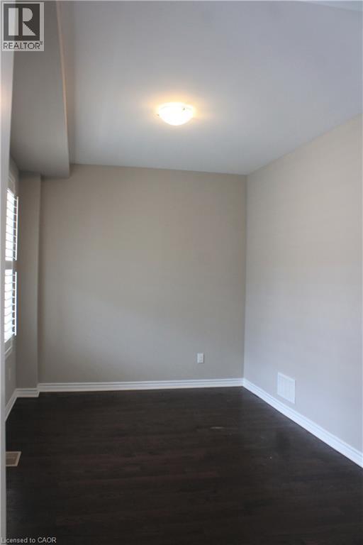 Room featuring dark wood-finish flooring, light-toned walls, and white trim molding - 31 Pointer Street Unit# Main Floor, Cambridge, ON - Indoor Photo Showing Other Room