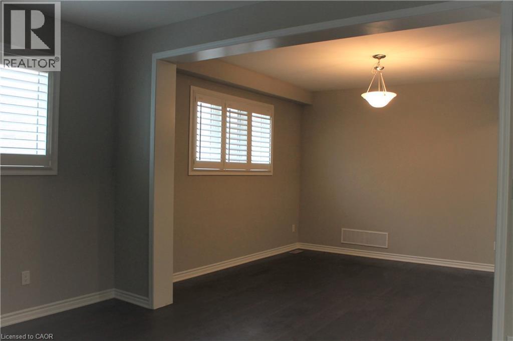 Interior space featuring wood-finish flooring, neutral wall tones, and white trim - 31 Pointer Street Unit# Main Floor, Cambridge, ON - Indoor Photo Showing Other Room