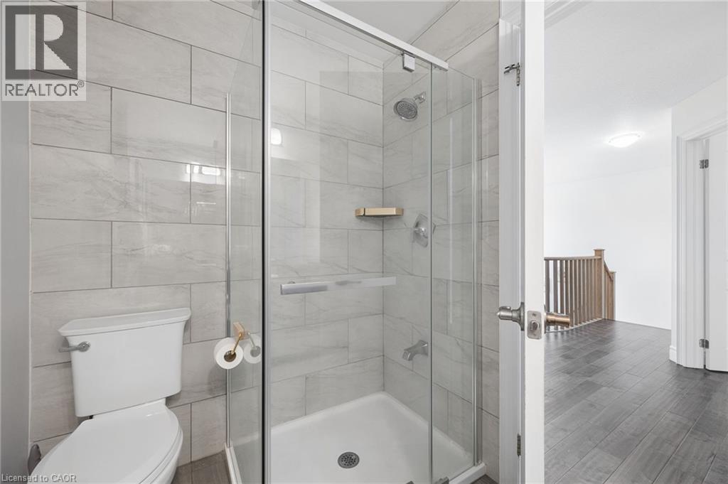 Bathroom featuring a glass-enclosed shower with light gray subway tile surround and a chrome shower head - 145 Redtail Street, Kitchener, ON - Indoor Photo Showing Bathroom