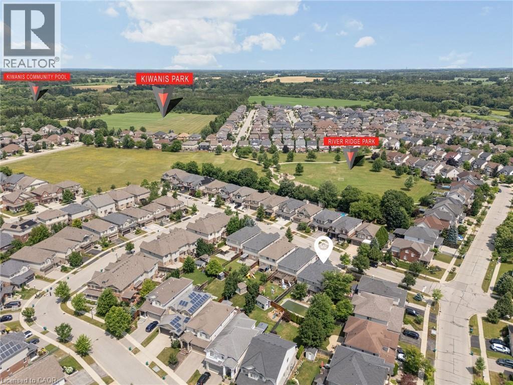 Aerial view showcasing a residential neighborhood with detached homes, green spaces, and a tree-lined perimeter - 145 Redtail Street, Kitchener, ON - Outdoor With View
