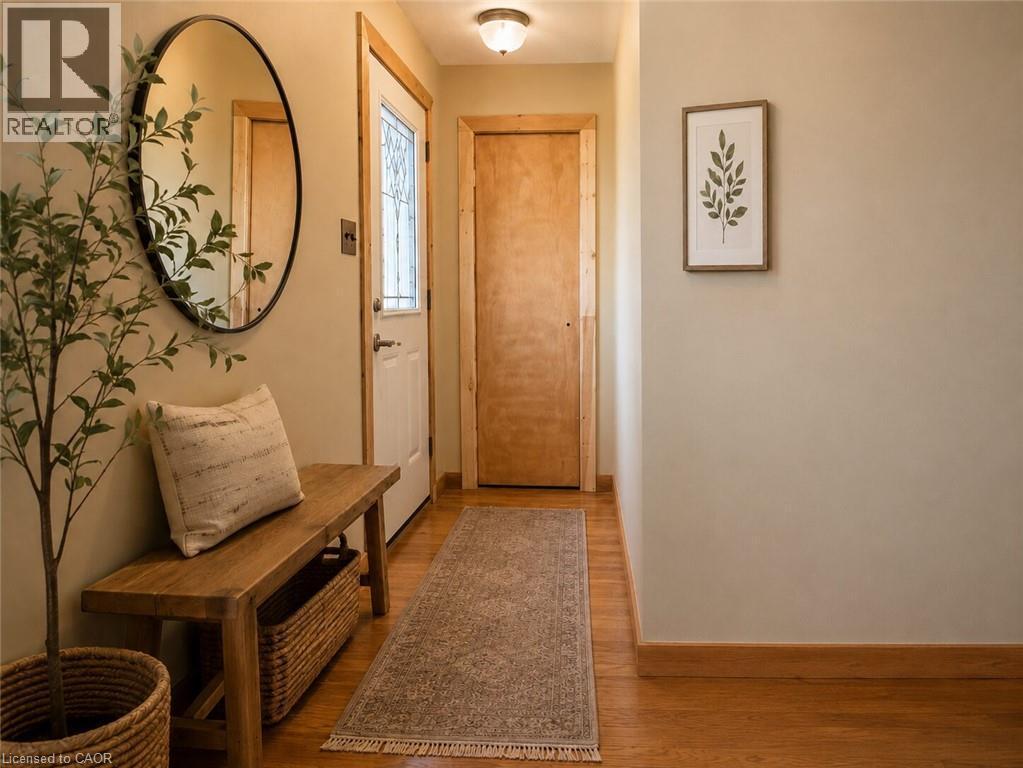 Entryway featuring a decorative transom door, wood-finish flooring, and natural wood trim - 274 East 38Th Street, Hamilton, ON - Indoor Photo Showing Other Room