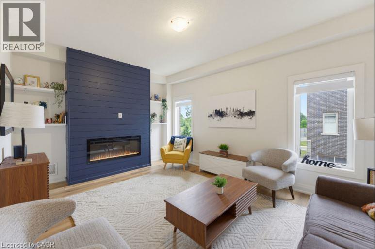 Living area featuring a prominent blue shiplap accent wall with an inset linear electric fireplace - 16 Raspberry Lane, Hamilton, ON - Indoor Photo Showing Living Room With Fireplace