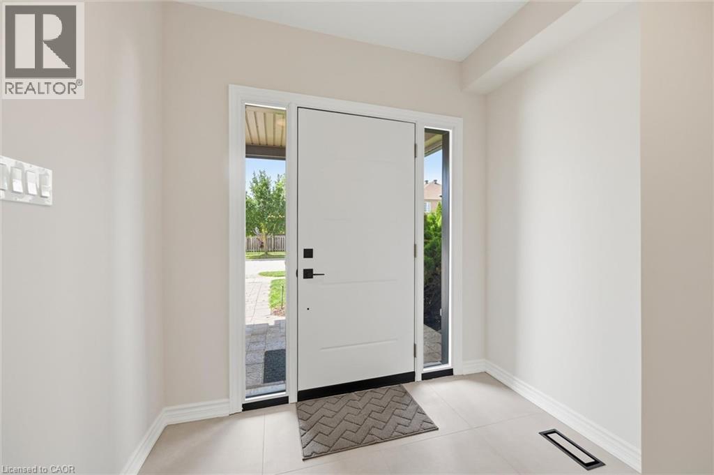 Entryway featuring a modern paneled door with sidelights, providing natural illumination - 5628 Stella Lane, Burlington, ON - Indoor Photo Showing Other Room