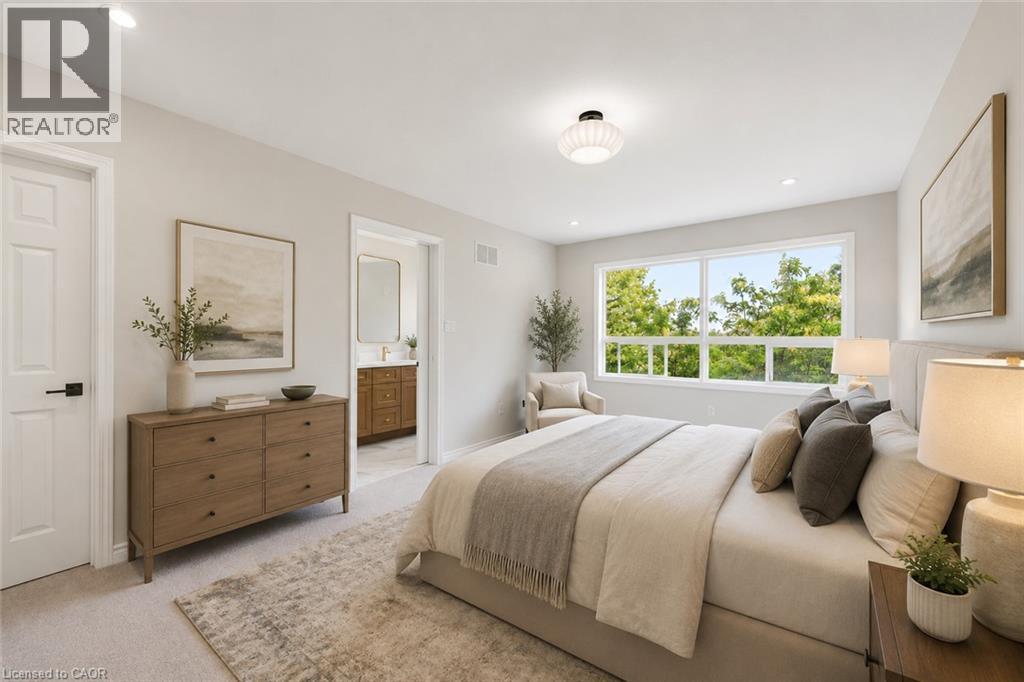 Spacious bedroom with light-toned carpeting and a large window overlooking lush greenery - 5628 Stella Lane, Burlington, ON - Indoor Photo Showing Bedroom