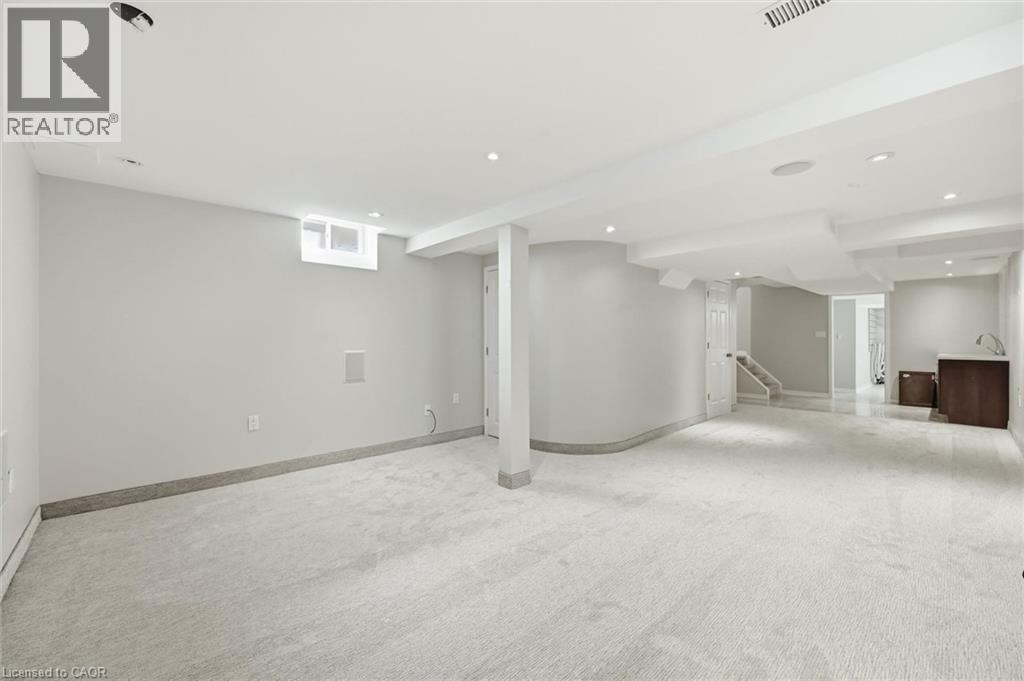 Spacious finished basement featuring light gray carpeting, recessed lighting, and a neutral color palette - 5628 Stella Lane, Burlington, ON - Indoor Photo Showing Basement
