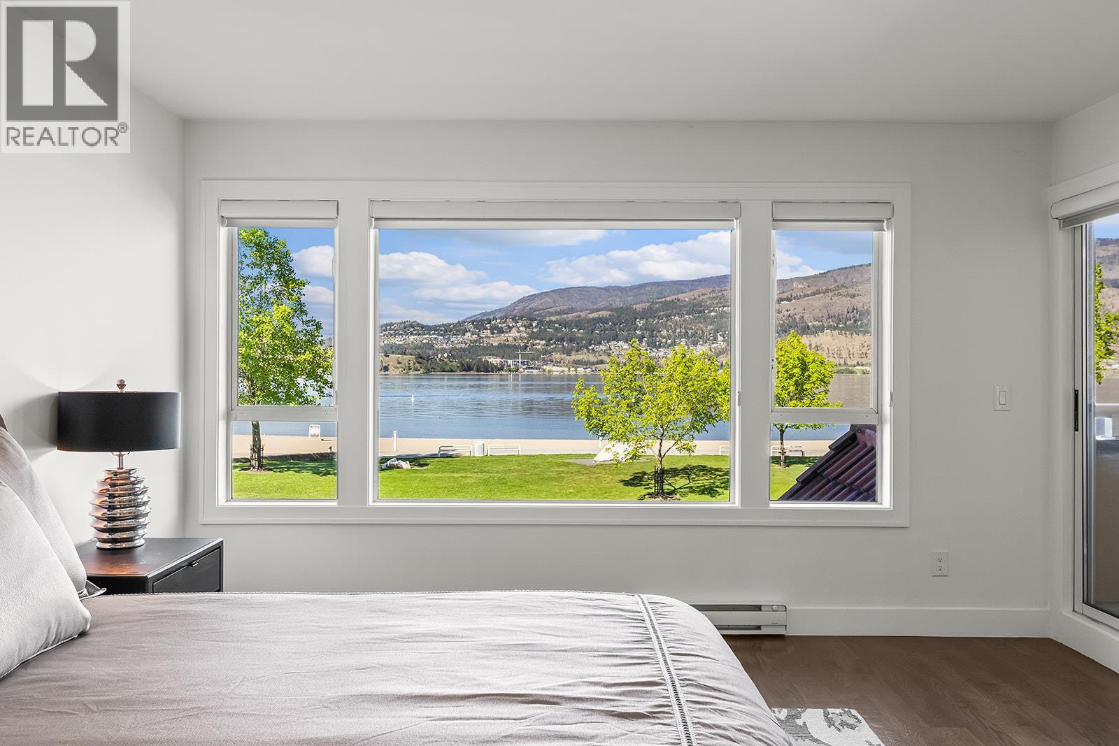 View of Okanagan Lake from Primary bedroom - 1156 Sunset Drive Unit# 123, Kelowna, BC - Indoor Photo Showing Bedroom