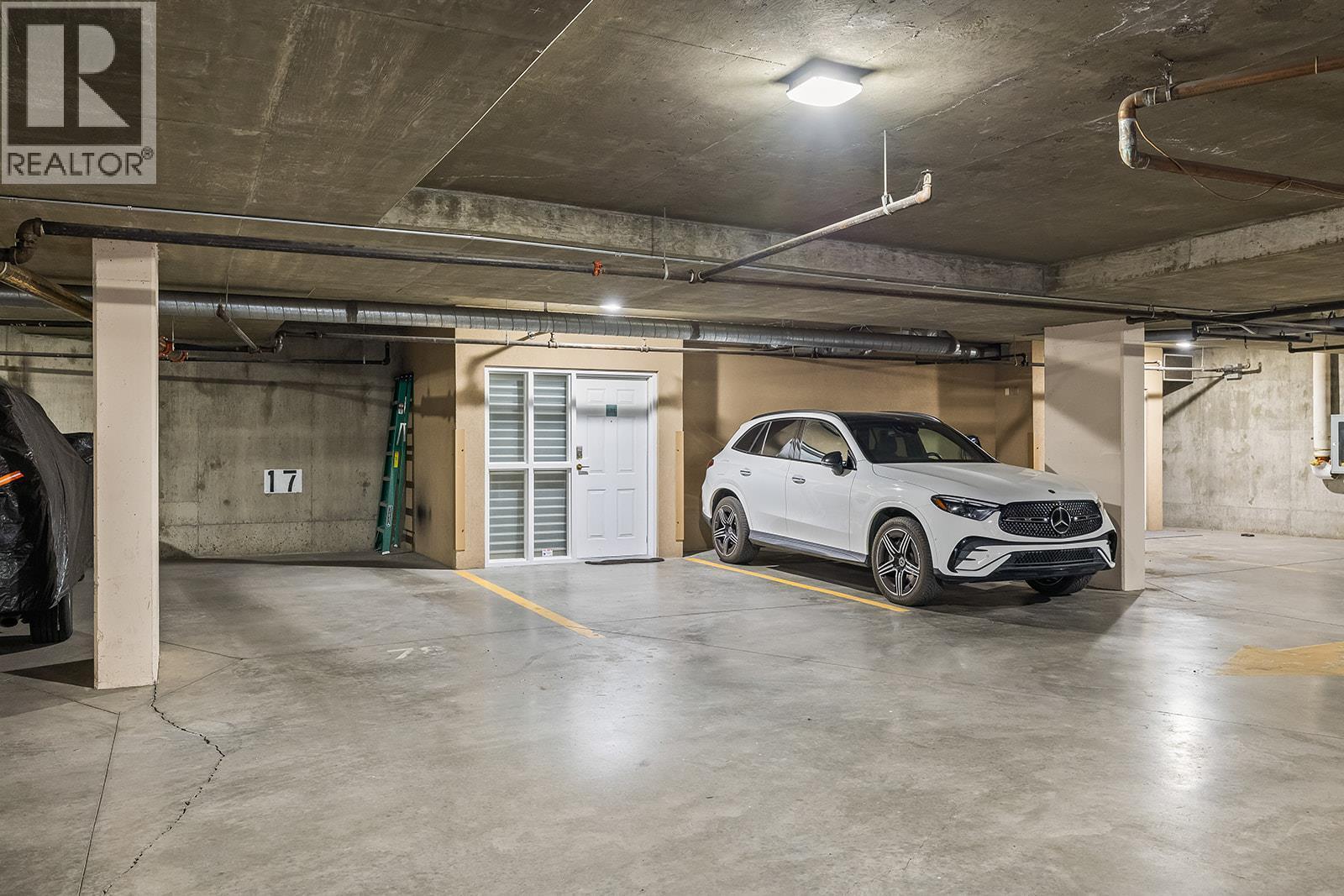 2 privately owned parking stalls by back entrance - 1156 Sunset Drive Unit# 123, Kelowna, BC - Indoor Photo Showing Garage