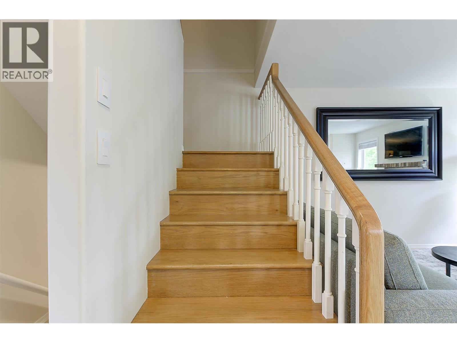 Stairs to the upper level - 133 Wyndham Crescent Unit# 110, Kelowna, BC - Indoor Photo Showing Other Room