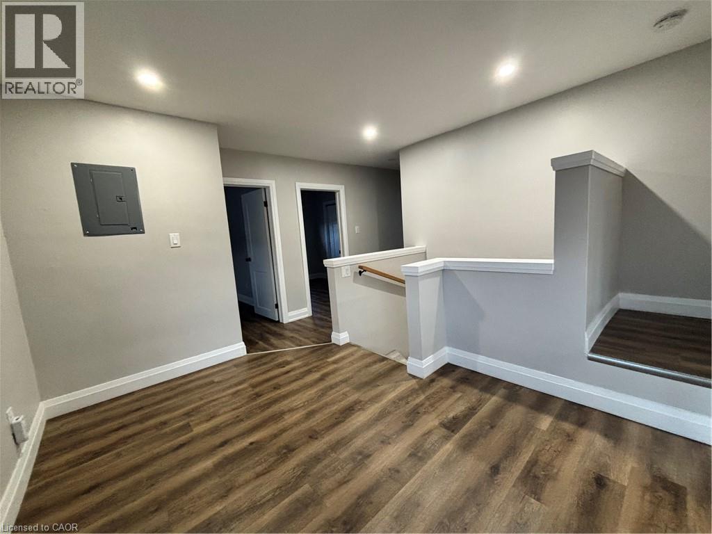 Open upper-level landing featuring wood-finish flooring, recessed lighting, and crisp white baseboards - 773 Lawrence Road, Hamilton, ON - Indoor Photo Showing Other Room