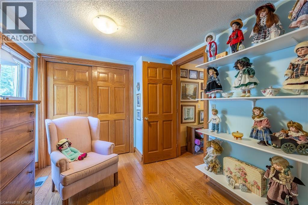 Warm-toned wood-finish flooring complements the interior door and closet doors - 5 Hawthorne Avenue, Simcoe, ON - Indoor