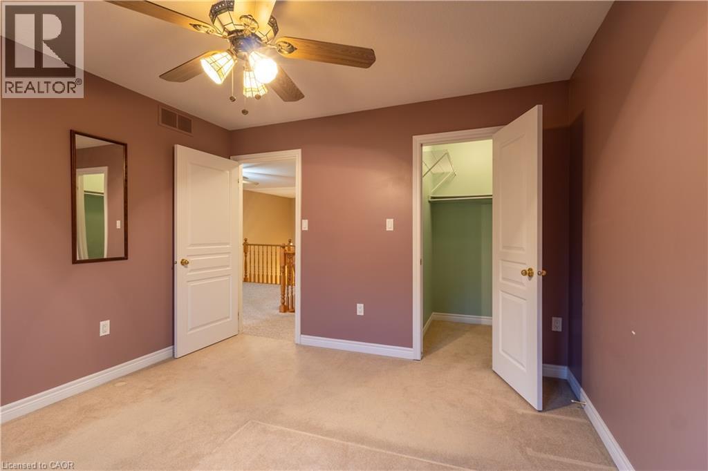 Carpeted room with a ceiling fan light fixture - 4066 Medland Drive, Burlington, ON - Indoor Photo Showing Other Room