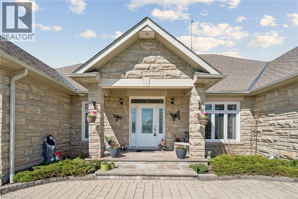 Stone facade entry with a prominent gable roofline - 10 Brolley Crescent, Thornton, ON - Outdoor