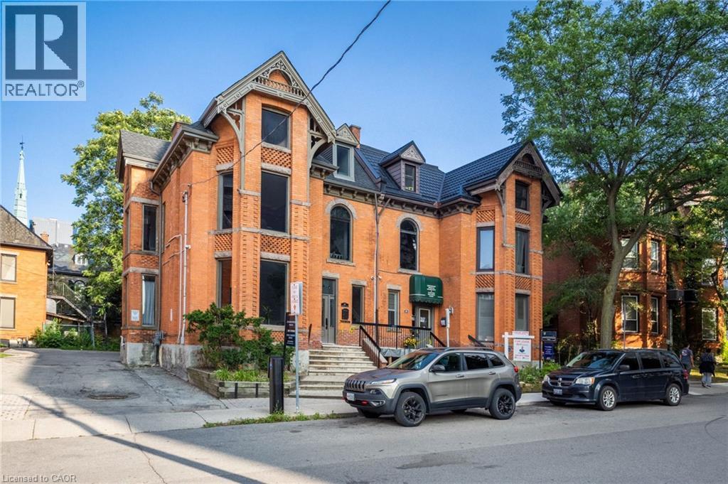 Brick exterior featuring decorative corbels and gables - 189 Hughson Street, Hamilton, ON