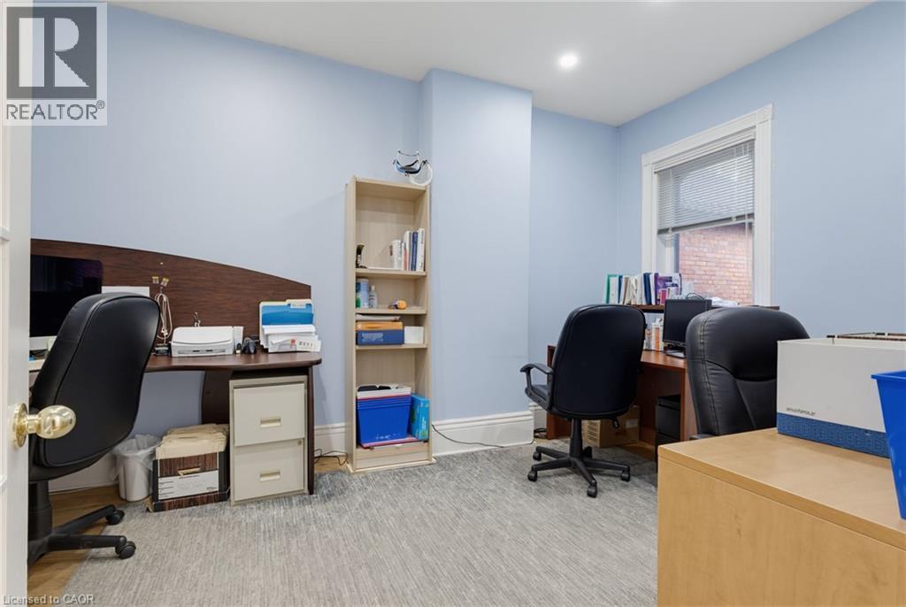 Interior room with light blue walls and a window featuring white trim - 189 Hughson Street, Hamilton, ON