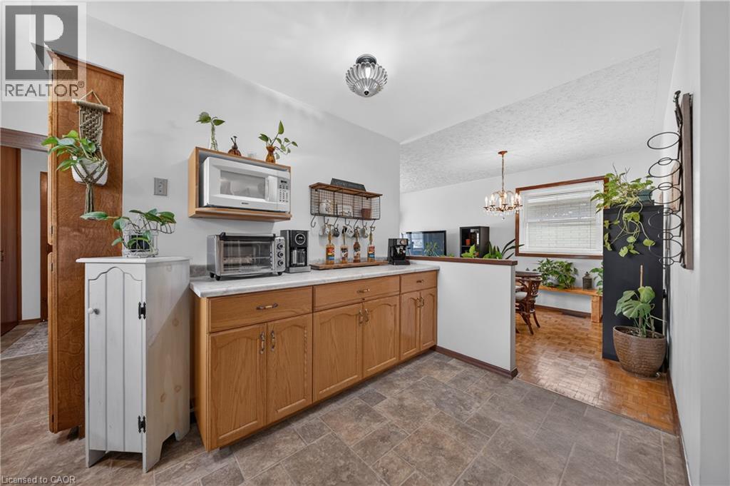 Kitchen featuring light wood cabinetry, light-toned countertop, and durable tile flooring - 111 Kimberly Crescent, Kitchener, ON - Indoor Photo Showing Kitchen